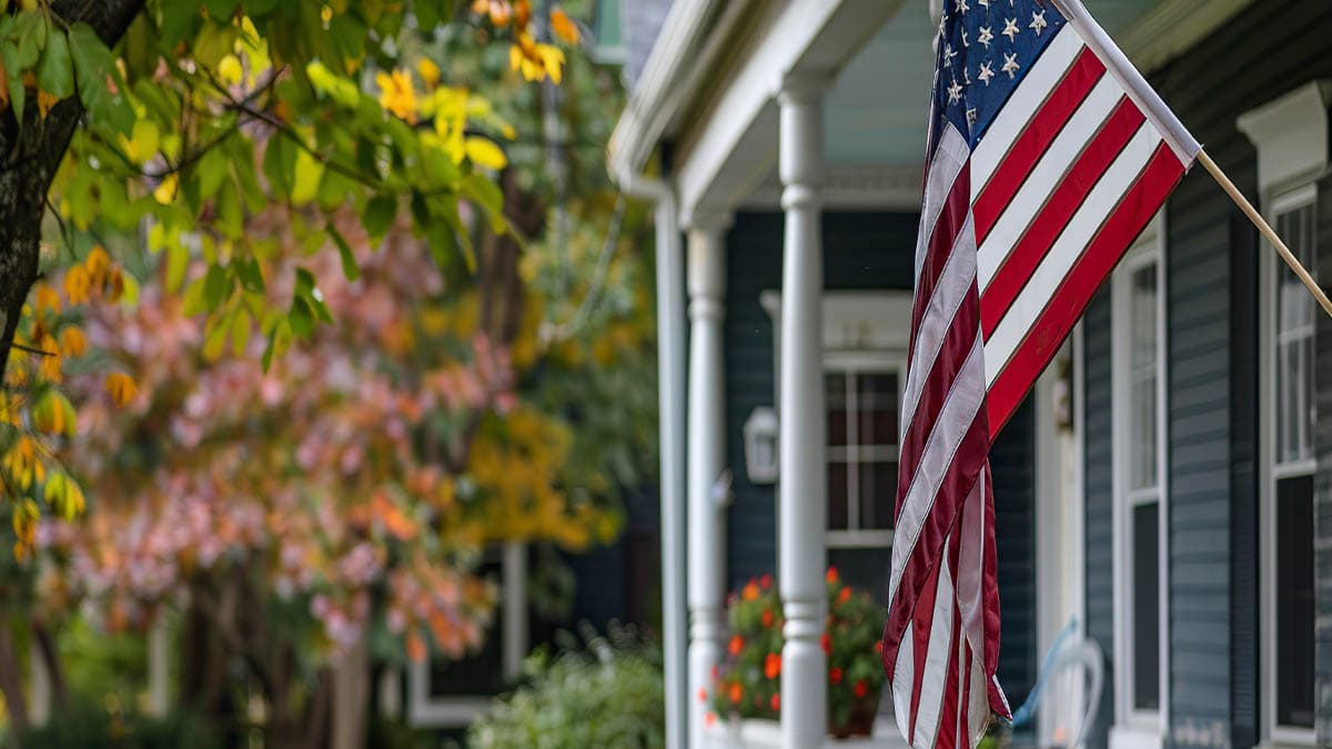 An American home with the U.S. flag on the porch